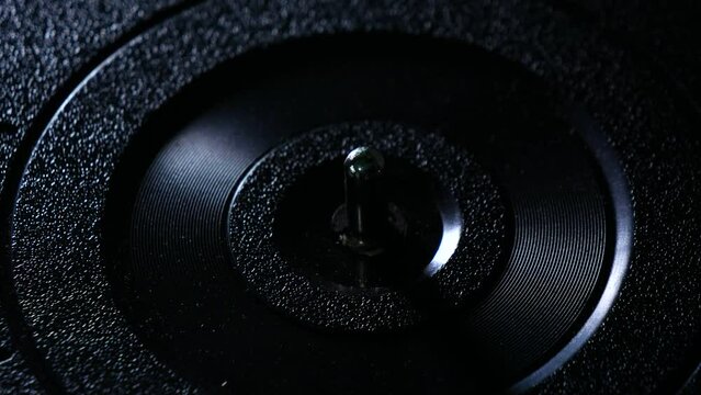 Putting a vinyl record onto a record player.