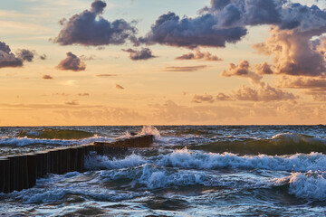 The rough Baltic Sea crashes the waves against the breakwater