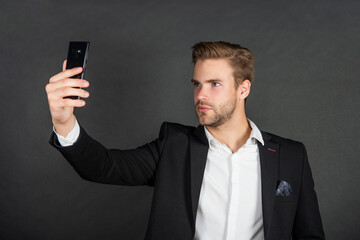 businessman making selfie. male business blogger. vlogger with cellphone