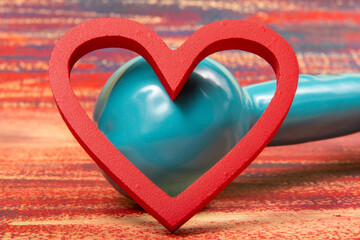 Heart shape and weight for physical activity to symbolize cardiovascular improvement