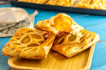 puff pastry with peach on a blue background. food concept