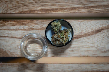 Glass bottle filled with dried cannabis flowers.