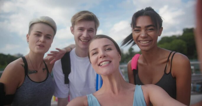 Group of multiracial people records video and greets viewers