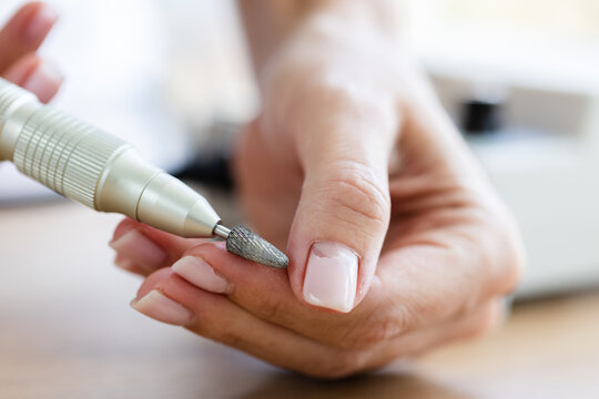 Removing shellac from the nails with fraser. Closeup. Selective focus.