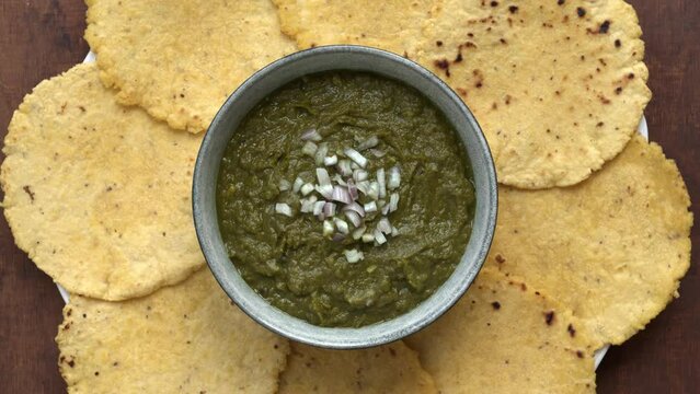 Punjabi Sarson ka saag and makki ki roti meal. Authentic north Indian dish. Top view, table spin.