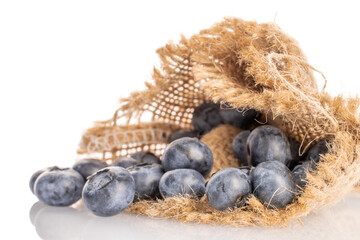 Ripe blueberries with jute napkin, close-up, on a white background.