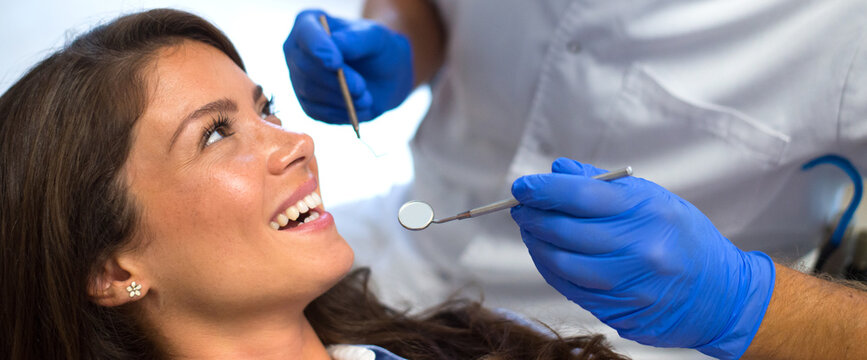 Young Woman Checking Her Teeth At The Dentist Clinic