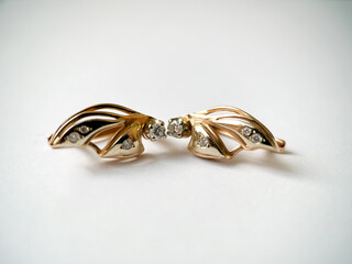 Gold earrings with diamonds close-up