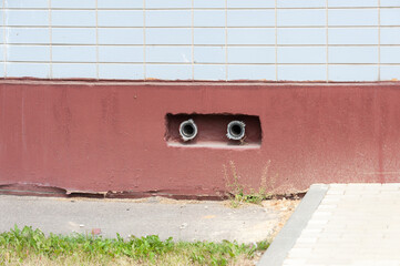 Two fire hydrants stick out of the wall
