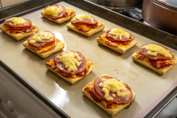 puff pastry mini pizza on a wooden background. food concept