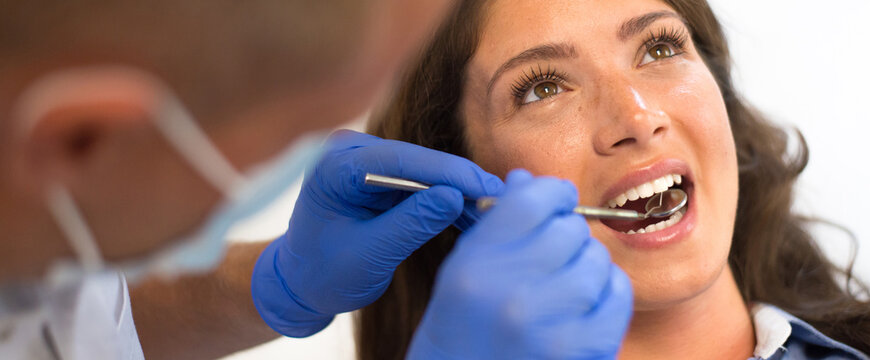 Young Woman Checking Her Teeth At The Dentist Clinic