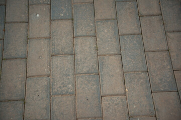 Granite cobblestoned pavement background. Stone pavement texture. Abstract background of cobblestone pavement close-up. Seamless texture.