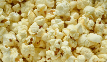 close up of salty popcorn arranging on white bowl
