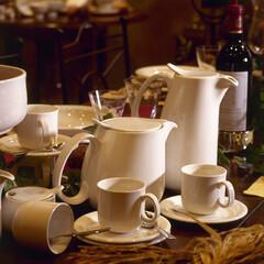 Tea and coffee pot with empty cups on luxury wedding table