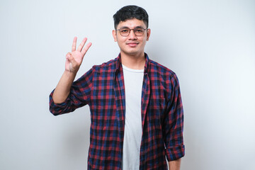 Naklejka premium Young handsome Asian man wearing casual clothes showing and pointing up with fingers number three while smiling confident and happy