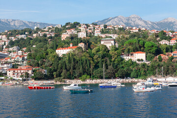 Fototapeta na wymiar Coastal landscape with beach and harbor in Montenegro . Summer vacation in Herceg Novi