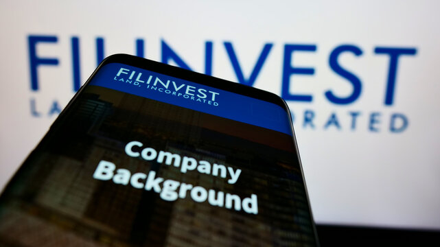 Stuttgart, Germany - 01-16-2022: Smartphone with webpage of real estate company Filinvest Land Inc. (FLI) on screen in front of business logo. Focus on top-left of phone display.