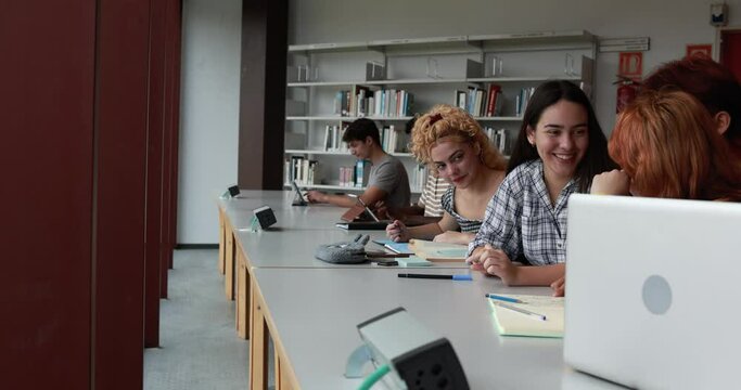Multiracial young students learing together inside school library
