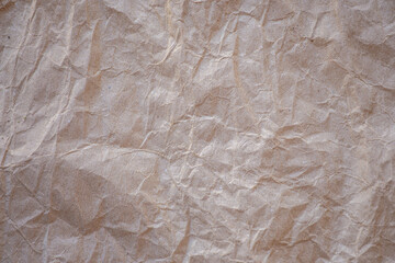 High detail of the abstract texture of the packaging paper. The texture of crumpled craft paper. Crumpled paper background top view.