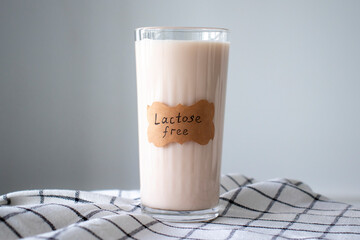 A glass of almond milk labeled Lactose Free - obrazy, fototapety, plakaty