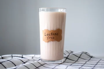 Fotobehang A glass of almond milk labeled Lactose Free © Anastasiia
