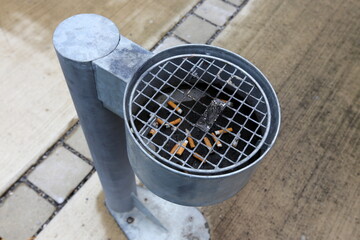 Ashtray - a container for tobacco ash, cigarette butts, cigars.