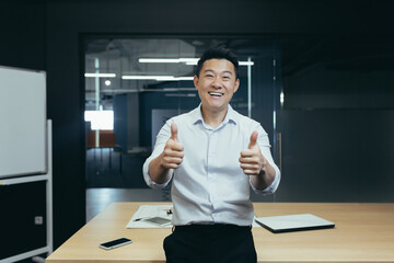 Portrait of successful asian businessman boss, man standing in office near table looking at camera...