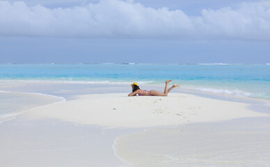 beautiful girl lies on the white sand on the island