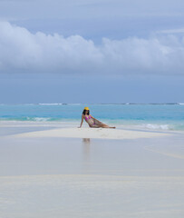 beautiful girl lies on the white sand on the island