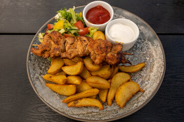 Grilled chicken with vegetarian salad and french fries