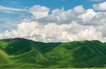 clouds shadow on green mountains