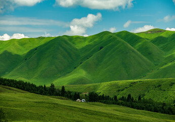 clouds shadow on green mountains