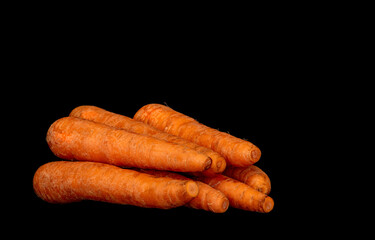 ripe vegetable root vegetable carrot on black background