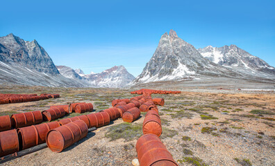 An abandoned US military base litters - Thousands of oil drums scattered across the land,  Greenland