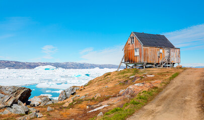 Red house in settlement of Tiniteqilaaq on Sermilik Fjord, East Greenland