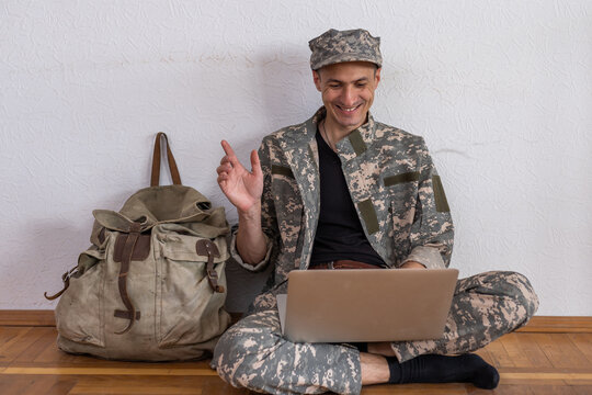 Happy Army Soldier Having Video Call Over Laptop And Waving To Someone