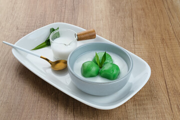 Kue Putri Mandi, Indonesian traditional dessert made from steamed glutinous rice filled with palm sugar paste and served with coconut milk. 
