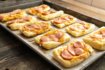puff pastry mini pizza on a wooden background. food concept