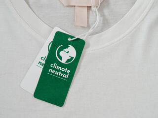 Carbon neutral t-shirt, Label Climate neutral on new clothes. Carbon neutral label concept in...