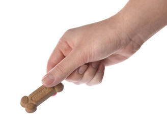 Woman holding bone shaped dog cookie on white background, closeup