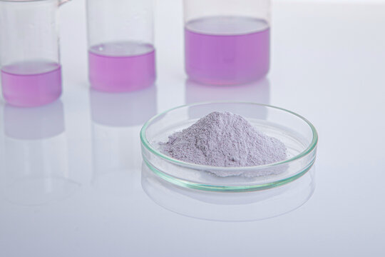 Powder in a petri dish. Soft background from laboratory flasks