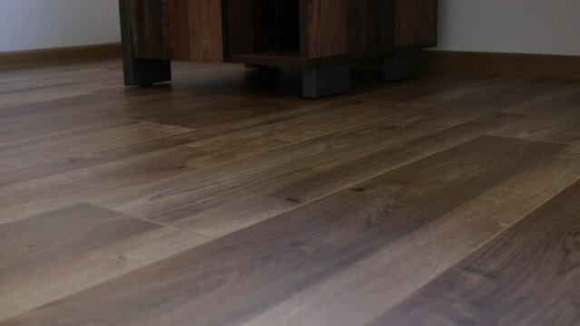 New laminate flooring. Laminated parquet with brown wooden texture