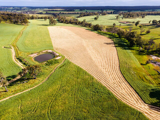 View over farm landscape with mown hay forming abstract patterns