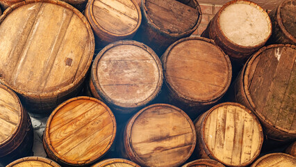 Barrels of wine in the cellar. Oak barrels for cognac storage close-up. Production of cognac in the...