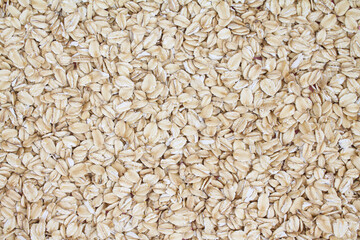 Close up top view rolled oats texture background, oat flakes, oatmeal