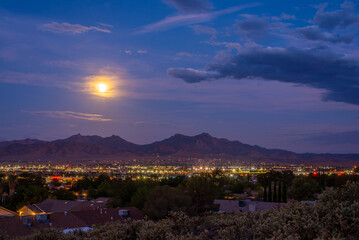 The moon rises over the city of Kingman, Arizona