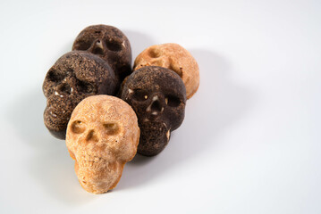Pumpkin spice and chocolate skull candy stacked on white background. 