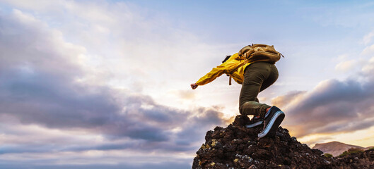 Man with backpack on the top of the mountain at sunset - Hiker climbing outdoors - Success, sport...