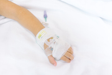 Close up kid hand with saline intravenous at hospital