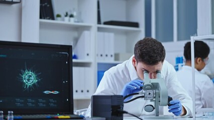 Scientist working in virology lab, examining pathology cells under microscope